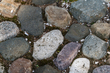Multi-colored stones of the ancient pavement as an interesting background.