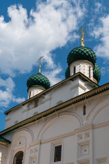 Fototapeta na wymiar Yaroslavl, Russia, July 4, 2023. A fragment of the wall of the Church of Elijah the Prophet with domes against the sky.