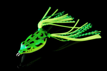 Silicone frog - top water bait for pike or large mouth bass fishing isolated on black
