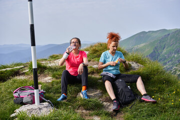 Women hiking on a trail in the rocky mountains