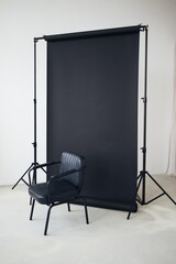black chair on a black background in a white photo studio