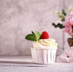 cupcake with whipped cream and fresh raspberries