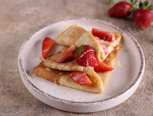 thin pancakes with berries for dessert