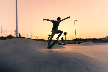 young man skates in a skate park at sunset y Gran Canaria. Canary Islands