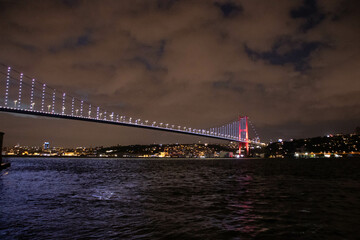 Fototapeta na wymiar Night Istanbul. Beautiful view of the night Bosphorus bridge and the city. All on fire at sunset.