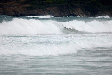 Abstract landscape with sea waves at the shore on a windy day.
