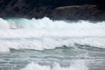 Abstract landscape with sea waves at the shore on a windy day.