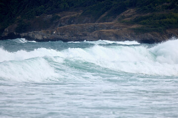 Abstract landscape with sea waves at the shore on a windy day.