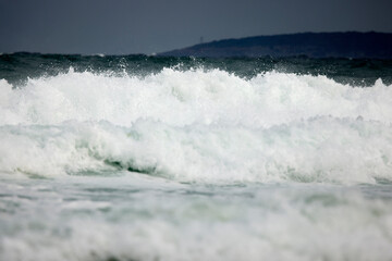 Abstract landscape with sea waves at the shore on a windy day.