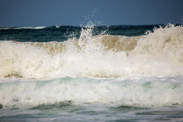 Abstract landscape with sea waves at the shore on a windy day.
