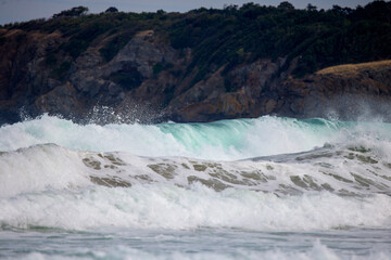Abstract landscape with sea waves at the shore on a windy day.