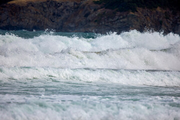Abstract landscape with sea waves at the shore on a windy day.