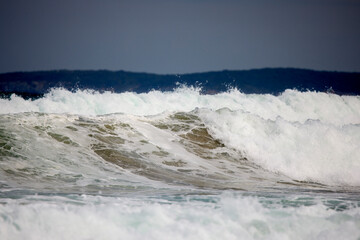 Abstract landscape with sea waves at the shore on a windy day.