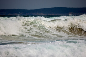 Fototapeta premium Abstract landscape with sea waves at the shore on a windy day.