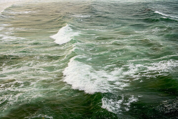Abstract landscape with sea waves at the shore on a windy day.