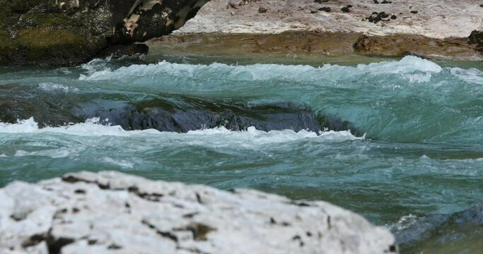 rapid flow of a mountain river with emerald water. High quality 4k footage