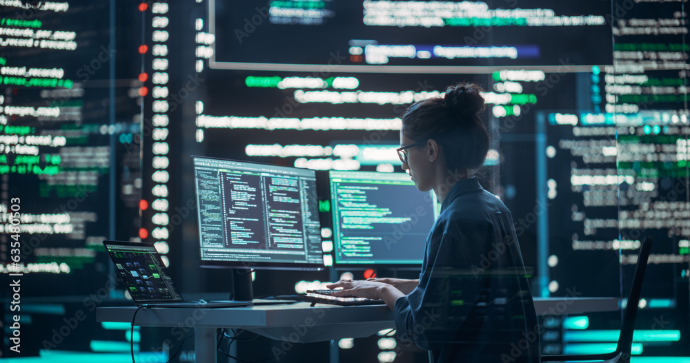 Fototapete Female Developer Thinking and Typing on Computer, Surrounded by Big Screens Showing Coding Language. Professional Programmer Working in a Modern Office, Running Coding Tests. Futuristic Programming