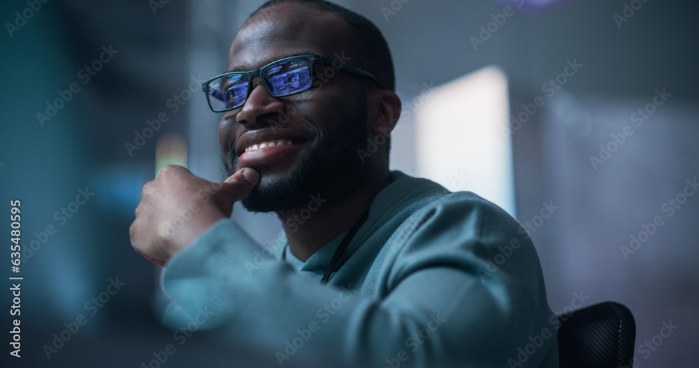 Aufkleber Close Up Of Black Male Developer Smiling Happily After Successfully Typing on Computer a Functioning Software Code. Professional Programmer Creating Mobile App, Screen Display Reflected on his Glasses