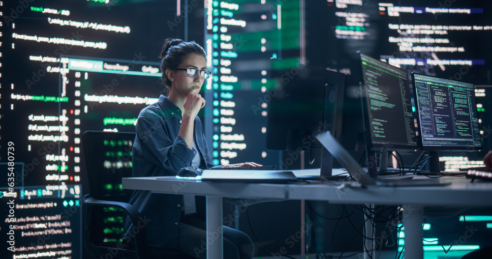Poster Focused Woman Working on a Computer, Typing Lines of Code that Appear on Big Screens Surrounding her in a Monitoring Room. Female Programmer Creating Innovative Software Using AI Data and System