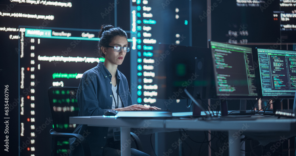 Fototapete Female Programmer Working in Monitoring Control Room, Surrounded by Big Screens Displaying Lines of Programming Language Code. Portrait of Woman Creating a Software. Futuristic Coding Concept.
