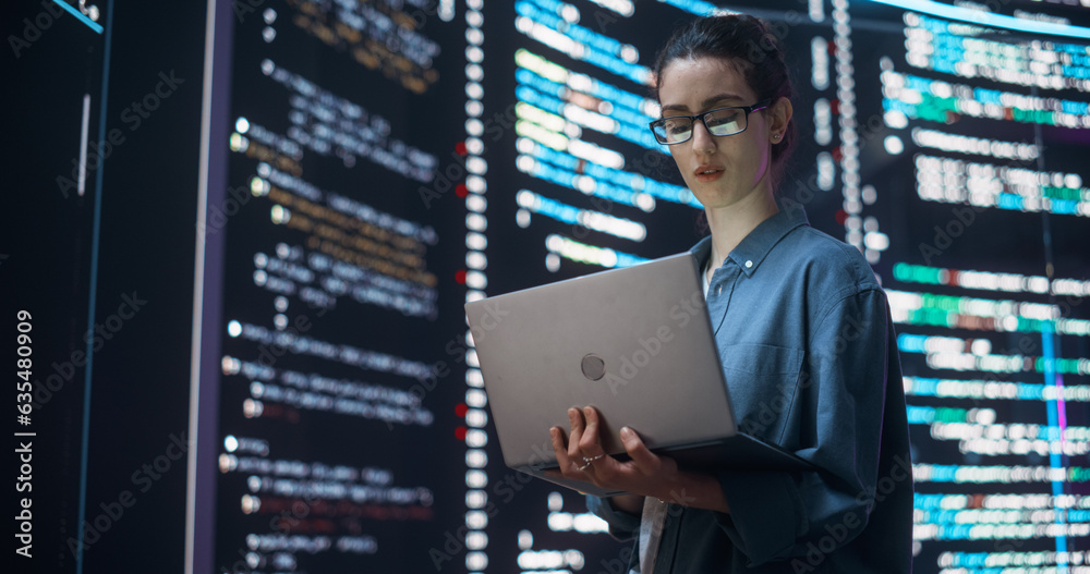 Fototapete Portrait of Woman Creating a Software and Coding, Surrounded by Big Screens Displaying Lines of Programming Language Code. Female Programmer Working in a Monitoring Control Room. Futuristic Concept
