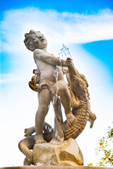 Fototapeta na wymiar Fountain in the form of a sculpture of a boy and a crocodile in Vienna in Austria.