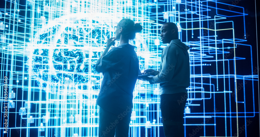 Fototapete Portrait of Two Diverse Colleagues Looking at a Big Screen with Neural Network 3D Visualisation. Professional Computer Data Scientists Discussing and Working on Monitoring Private Information