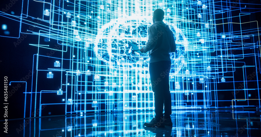 Fototapete Back View of Young Man Looking at a Big Screen with Neural Network 3D Visualisation. Professional Computer Data Science Engineer Working in System Control and Monitoring Telecommunications