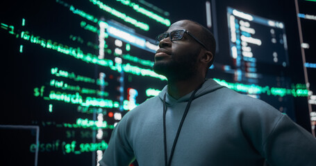 Portrait of Worried Professional Programmer Fixing a Bug, Dealing with Crashing System. Young Black Man Looking at Big Digital Screens Glitching While Displaying Code Lines and Thinking of Solutions