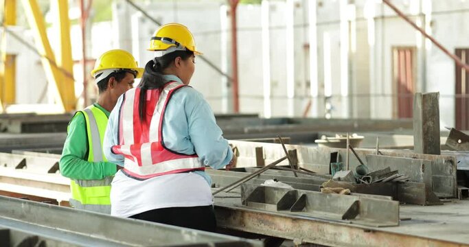 Specialists engineering female and construction asian man worker working at Prefabricated concrete walls factory. Safety hard hat helmet