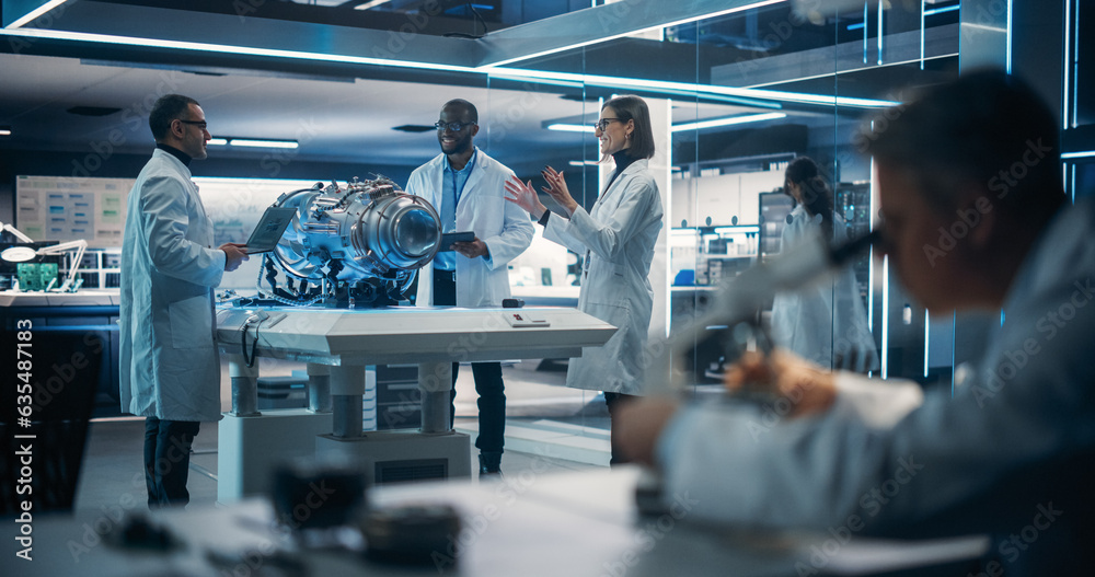 Poster Propulsion Engineer, Scientist and Operators Working on an Innovative Turbine Motor, Standing with Computers in Scientific Technology Facility. Out Of Focus Engineer Using Microscope On Fore Ground.