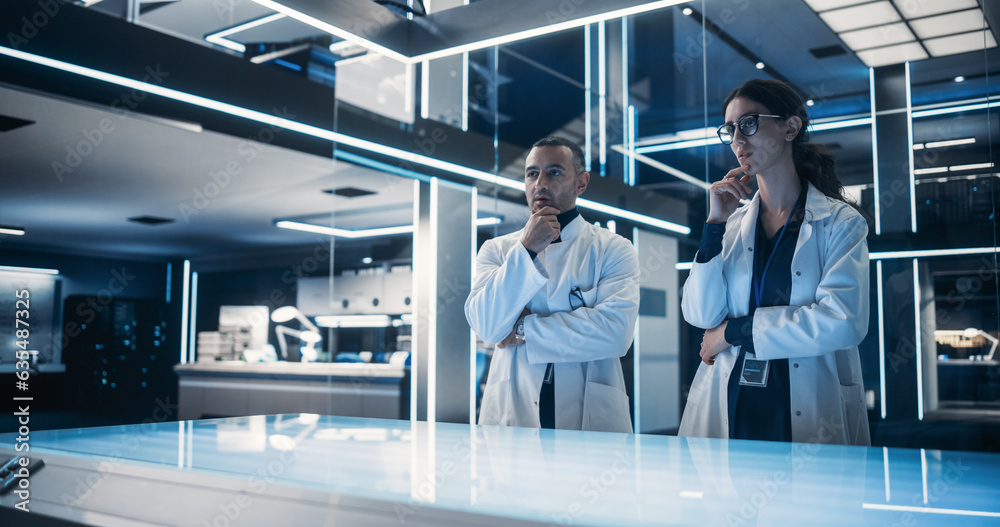 Leinwandbilder multiethnic male and female scientists standing in the high-tech laboratory next to the table. profe