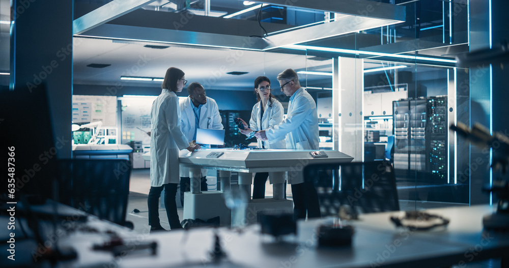 Poster Team of Industrial Engineers Working on a Bionic Robot Arm at a Startup Factory. Multiethnic Male and Female Scientists Having a Conversation About an Electronic Component for a Humanoid AI Robot