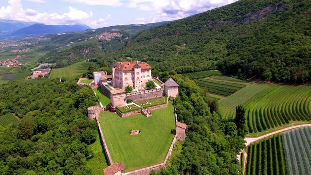 Italy .Most impressive and scenic well preserved medieval castles of Italy - Castel Thun in beautifull valley of apple trees Val Di Non. Trentino region, province of Trento. aerial drone video