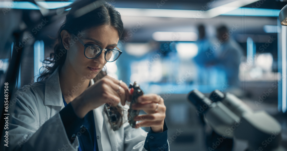 Poster Focused Professional Female Engineer Working on Electronic Circuit Boards. Industrial Robotics Specialists in Laboratory Coats Developing Mobile AI Robot in an Advanced Technology Factory Facility.