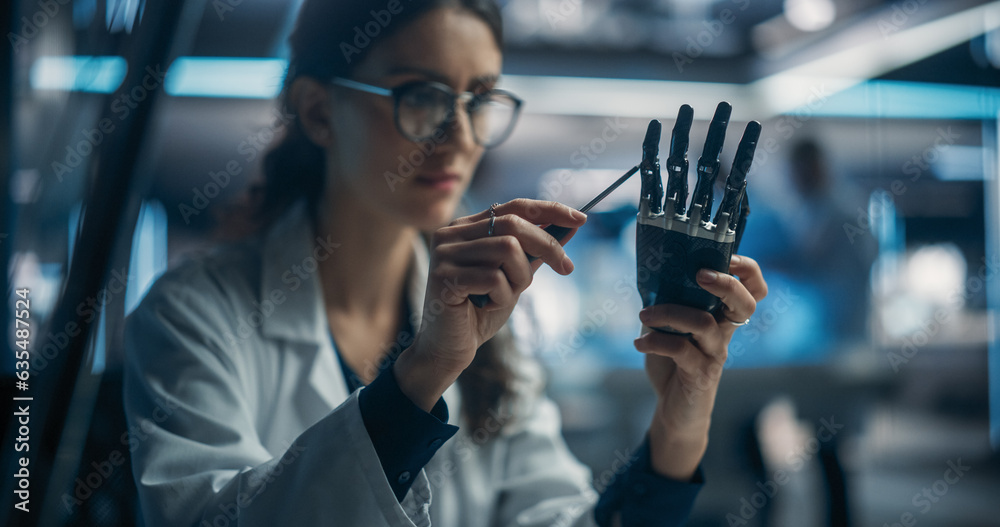 Poster Portrait of Young Female Scientist Working in Technological Research and Development Company, Assembling an Innovative Bionic Prosthetic Hand. Engineer Working on Technology for Physically Impaired