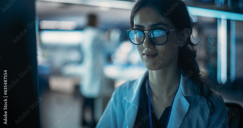 Poster Portrait of a Professional Female Specialist Using Computer at Work in Research and Development Agency. Young Multiethnic Engineer, Developer or Scientist Working in Development Technology Office