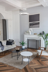 a chic expensive bright interior of a huge living room in a historic mansion with arched arches, columns and white walls decorated with ornaments and stucco.