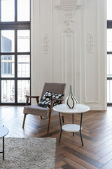 a chic expensive bright interior of a huge living room in a historic mansion with arched arches, columns and white walls decorated with ornaments and stucco.