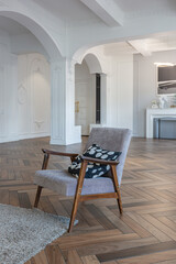 a chic expensive bright interior of a huge living room in a historic mansion with arched arches, columns and white walls decorated with ornaments and stucco.