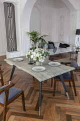 a chic expensive bright interior of a huge living room in a historic mansion with arched arches, columns and white walls decorated with ornaments and stucco.