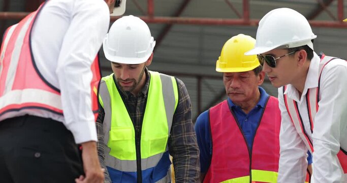 Success teamwork. Ethnic diversity worker people. Group of professional Construction engineering people wearing hardhat safety helmet meeting at Prefabricated concrete walls Industry Factory