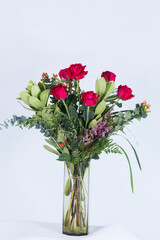 Many kinds of beautiful flowers put in vase on a white background