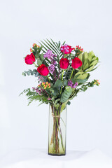 Many kinds of beautiful flowers put in vase on a white background