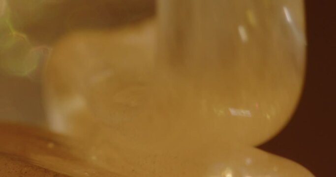 Cosmetic cream with gold is poured into a jar