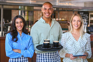 Portrait Of Multi-Cultural Staff Team With Digital Tablet Working In Restaurant Or Coffee Shop