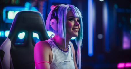 Portrait of a Happy Cosplay Girl in Headphones Talking with Friends Online on a Computer. Stylish...