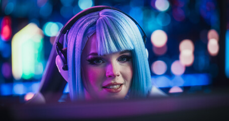 Close Up Portrait of a Beautiful Young Female Wearing Headphones, Talking with Friends Online on a Computer. Popular Cosplay Streamer Chatting with Internet Fans. Gamer Girl Playing Video Games