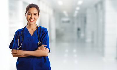 Portrait asian female surgeon healthy in blue uniform with stethoscope standing crossed hands...