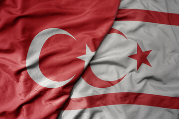 big waving national colorful flag of turkey and national flag of northern cyprus .